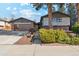 Charming two-story home with brick accents, attached garage, and a well-maintained front yard landscape at 10121 W 70Th Dr, Arvada, CO 80004