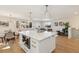 Bright, open kitchen with a large island, hardwood floors, and a seamless transition to the living area at 10121 W 70Th Dr, Arvada, CO 80004