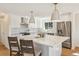 Modern kitchen with stainless steel appliances, a large island, and stylish pendant lighting at 10121 W 70Th Dr, Arvada, CO 80004