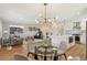 Open-concept living room with hardwood floors, modern lighting, and seamless flow into the kitchen and dining area at 10121 W 70Th Dr, Arvada, CO 80004