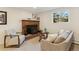 Inviting living room with a brick fireplace, cozy seating, and natural light at 10121 W 70Th Dr, Arvada, CO 80004