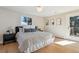 Bedroom features a door to the exterior, a large window, light colored walls and hardwood floors at 10121 W 70Th Dr, Arvada, CO 80004