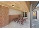 Covered patio area with picnic table and seating, plus adjacent back door and sliding glass door at 10121 W 70Th Dr, Arvada, CO 80004