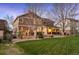 Beautiful backyard with a covered patio, outdoor seating, and a well-maintained lawn at 15946 W Ellsworth Ln, Golden, CO 80401