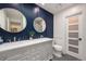 Stylish bathroom featuring a double vanity, and modern lighting at 15946 W Ellsworth Ln, Golden, CO 80401