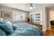 Comfortable bedroom with a ceiling fan and decorative closet door at 15946 W Ellsworth Ln, Golden, CO 80401