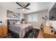 Comfortable bedroom featuring a ceiling fan, hard wood floors, and a guitar at 15946 W Ellsworth Ln, Golden, CO 80401