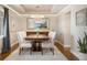 Formal dining room with tray ceilings, hardwood floors, a modern chandelier, and neutral decor at 15946 W Ellsworth Ln, Golden, CO 80401