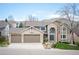 Attractive two-story home featuring a brick facade, three-car garage, and well-maintained lawn at 15946 W Ellsworth Ln, Golden, CO 80401