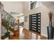 Grand foyer with soaring ceilings, hardwood floors, modern front door, and elegant staircase at 15946 W Ellsworth Ln, Golden, CO 80401