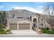 Stunning two-story home with brick accents, arched entryway, and a spacious three car garage at 15946 W Ellsworth Ln, Golden, CO 80401