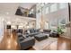 Open-concept living room showcasing hardwood floors, a fireplace, a large sectional, and balcony access at 15946 W Ellsworth Ln, Golden, CO 80401