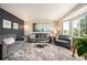 Cozy living room featuring a plush rug, comfortable seating, and bright natural light from the bay window at 15946 W Ellsworth Ln, Golden, CO 80401