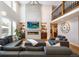 Stylish living room featuring a stone fireplace, built-in shelves, and a view of the upper level at 15946 W Ellsworth Ln, Golden, CO 80401