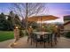 Inviting outdoor patio with wrought iron table and chairs, perfect for dining al fresco against mountain views at 15946 W Ellsworth Ln, Golden, CO 80401