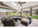 Covered outdoor patio with comfortable seating, a ceiling fan, and a view of the landscaped backyard at 15946 W Ellsworth Ln, Golden, CO 80401