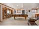 Large recreation room featuring pool table, custom bookshelves and ample space for entertaining at 15946 W Ellsworth Ln, Golden, CO 80401