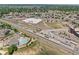 Aerial view of community train station, pool, apartments, and shopping center surrounded by landscaping at 837 E 98Th Ave # 405, Thornton, CO 80229