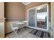 Cozy balcony features a small table, chairs, and access to the interior at 837 E 98Th Ave # 405, Thornton, CO 80229