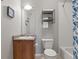 Compact bathroom showcasing a wood vanity, framed wall art, and shower at 837 E 98Th Ave # 405, Thornton, CO 80229