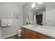 The bathroom features a single vanity, light wood cabinets, and a shower with stone surround and chrome fixtures at 837 E 98Th Ave # 405, Thornton, CO 80229