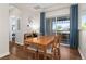 Inviting dining area features wood floors and a sliding glass door leading to outdoor space, perfect for entertaining guests at 837 E 98Th Ave # 405, Thornton, CO 80229