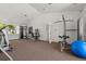 Bright gym featuring multiple weight machines, free weights, carpeted floors, and natural light from large windows at 837 E 98Th Ave # 405, Thornton, CO 80229