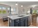 Bright kitchen featuring an island with a sink, stainless steel appliances, and an open floorplan at 837 E 98Th Ave # 405, Thornton, CO 80229