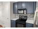 The kitchen features dark cabinets, subway backsplash and stainless appliances at 837 E 98Th Ave # 405, Thornton, CO 80229