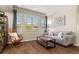 Cozy living room featuring natural light, hardwood floors, a comfortable sofa, and stylish decor at 837 E 98Th Ave # 405, Thornton, CO 80229