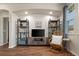 Cozy living room featuring wood floors, recessed lighting, media center and bookshelves, offering a comfortable and stylish space at 837 E 98Th Ave # 405, Thornton, CO 80229
