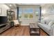 Cozy living room featuring natural light, hardwood floors, a comfortable sofa, and stylish decor at 837 E 98Th Ave # 405, Thornton, CO 80229