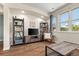 Cozy living room featuring wood floors, recessed lighting, media center and bookshelves, offering a comfortable and stylish space at 837 E 98Th Ave # 405, Thornton, CO 80229