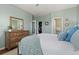 Well-lit bedroom features wood-look floors, a bed with colorful pillows and opens to a large closet and ensuite bathroom at 837 E 98Th Ave # 405, Thornton, CO 80229