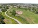 Aerial view of a community playground with slides, swings, and climbing structures on a grassy hill at 837 E 98Th Ave # 405, Thornton, CO 80229