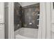 Close up view of bathtub with dark brown tiled shower and white shower curtain at 837 E 98Th Ave # 405, Thornton, CO 80229