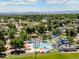 Aerial view of community water park with pools, water slides, and plenty of seating surrounded by mature trees at 837 E 98Th Ave # 405, Thornton, CO 80229
