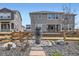 Backyard with mature trees, a decorative stone vase, and a view of the home's rear exterior at 1832 Marlowe Cir, Erie, CO 80516