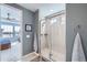 Well-lit bathroom with a glass-enclosed shower and a view into a large bedroom at 1832 Marlowe Cir, Erie, CO 80516