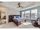 Bright bedroom with large windows, tray ceilings and ceiling fan at 1832 Marlowe Cir, Erie, CO 80516