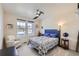 Comfortable bedroom with ample light, complemented by a ceiling fan and relaxing armchair at 1832 Marlowe Cir, Erie, CO 80516