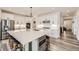 Spacious kitchen with white cabinets, a large center island, and stainless steel appliances at 1832 Marlowe Cir, Erie, CO 80516