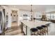 Spacious kitchen with white cabinets, a large center island, and stainless steel appliances at 1832 Marlowe Cir, Erie, CO 80516