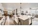 Open-concept kitchen showcasing a large island, modern appliances, and seamless flow to the dining and living areas at 1832 Marlowe Cir, Erie, CO 80516