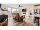 Open-concept living room featuring modern fireplace, large windows, and hardwood floors at 1832 Marlowe Cir, Erie, CO 80516