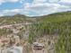 A beautiful aerial shot of a house nestled among the trees, with a paved road leading to it at 800 Highway 72, Golden, CO 80403
