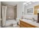 Bathroom with tiled tub/shower, vanity with sink and tile countertop at 800 Highway 72, Golden, CO 80403