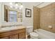 Bright bathroom featuring a vanity with tile countertop, a framed mirror, and a tub/shower combo with tiled walls at 800 Highway 72, Golden, CO 80403