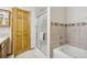 Bathroom features tiled walls, a glass-enclosed shower, and a wood door, all complemented by a neutral color scheme at 800 Highway 72, Golden, CO 80403