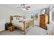 Charming bedroom featuring log bed frame, plush carpet, ceiling fan and natural light from a window with mountain views at 800 Highway 72, Golden, CO 80403